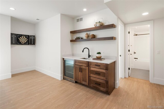 1195 S Milwaukee St, Denver, CO 80210 - indoor wet bar featuring beverage cooler, light wood-type flooring, baseboards, and recessed lighting