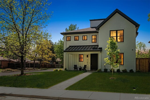 1195 S Milwaukee St, Denver, CO 80210 - view of front of home with a standing seam roof, board and batten siding, brick siding, and metal roof