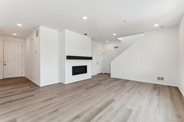 unfurnished living room featuring light hardwood / wood-style floors