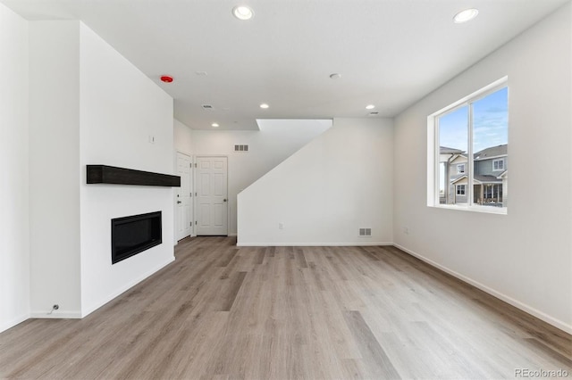 unfurnished living room featuring light hardwood / wood-style floors