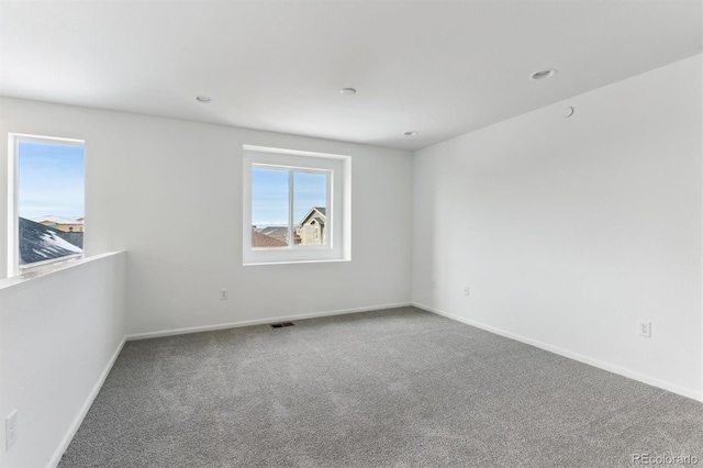 unfurnished room featuring carpet