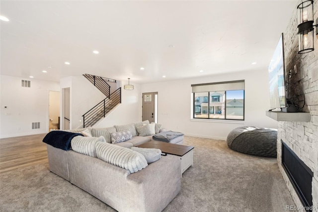 living room featuring light colored carpet and a fireplace