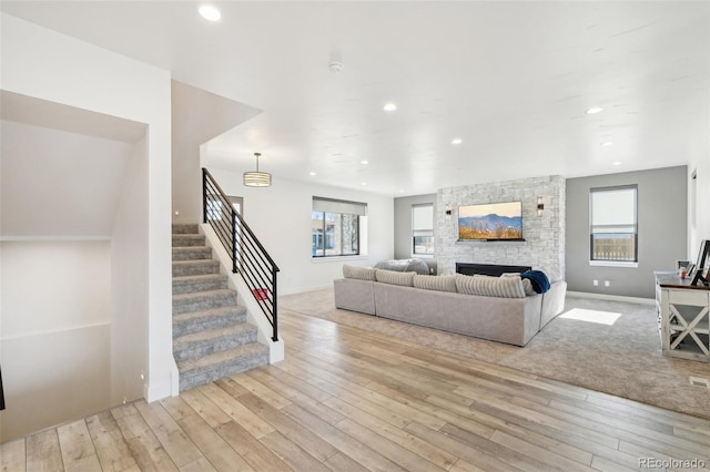 living room featuring a fireplace and light hardwood / wood-style floors