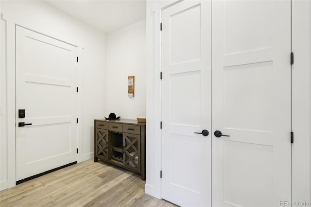 hall with light hardwood / wood-style flooring