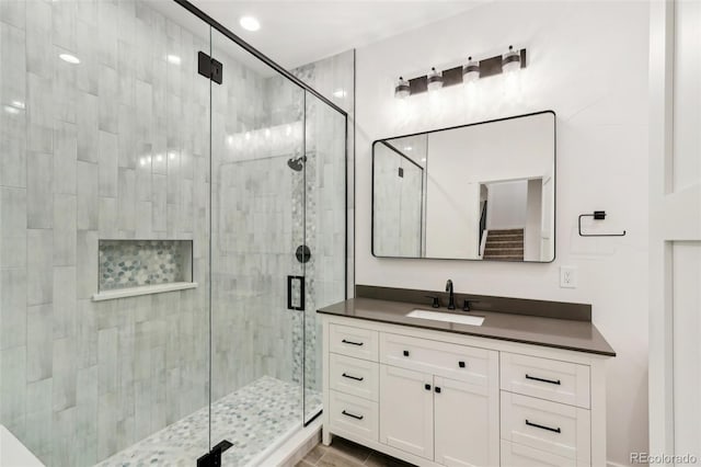 bathroom with vanity, tile patterned flooring, and a shower with door