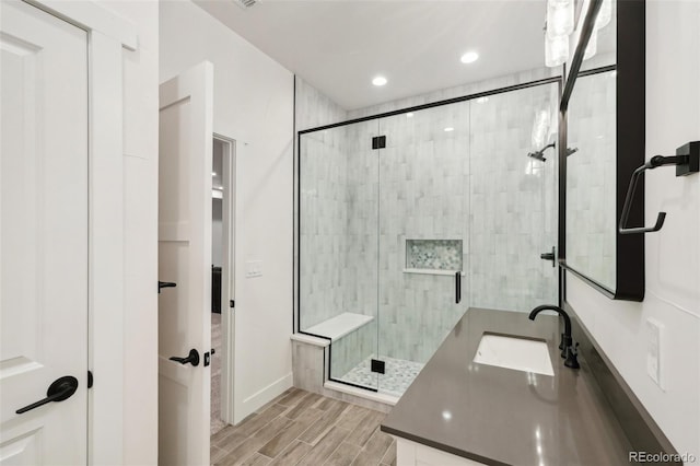 bathroom with vanity and a shower with door