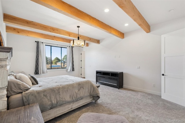 carpeted bedroom with beamed ceiling