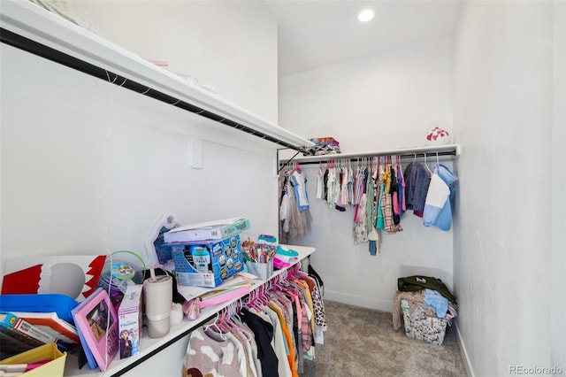 walk in closet featuring light colored carpet