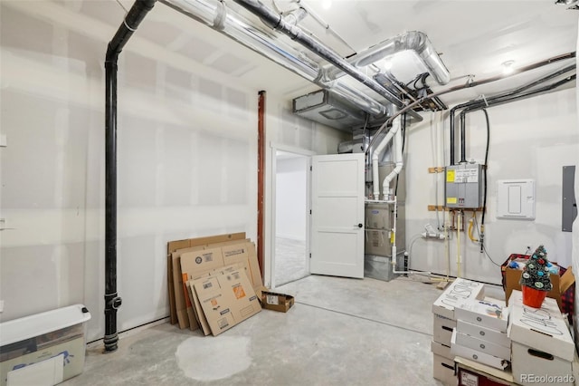 basement featuring electric panel and water heater