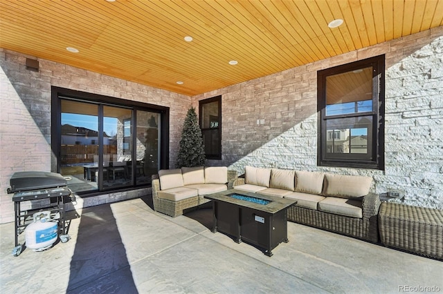 view of patio with grilling area and an outdoor living space with a fire pit