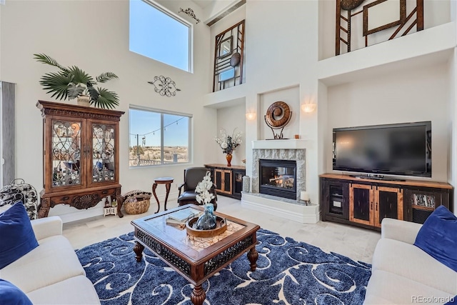 living area featuring a healthy amount of sunlight and a premium fireplace