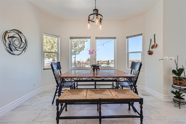 dining space with an inviting chandelier and baseboards