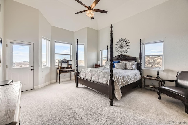 bedroom featuring baseboards, high vaulted ceiling, a ceiling fan, and light colored carpet