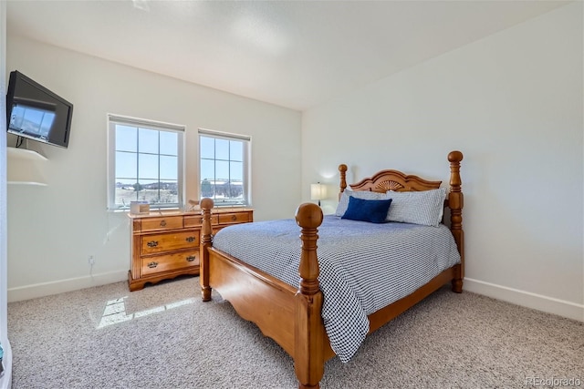 bedroom featuring light carpet and baseboards