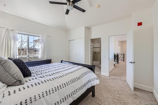 bedroom featuring a closet, light colored carpet, ceiling fan, high vaulted ceiling, and baseboards