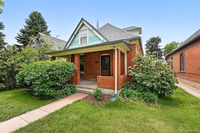 3330 W 30th Ave, Denver, CO 80211 - view of front of home featuring a porch, a front lawn, brick siding, and roof with shingles