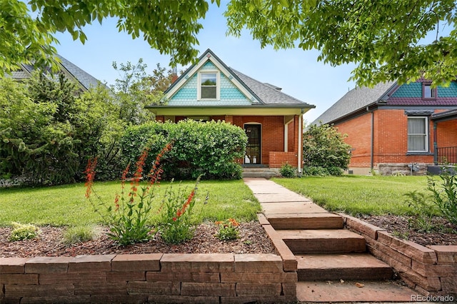 3330 W 30th Ave, Denver, CO 80211 - victorian house with covered porch, a front yard, and brick siding