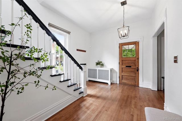 3330 W 30th Ave, Denver, CO 80211 - entrance foyer featuring stairs, light wood finished floors, a chandelier, and baseboards