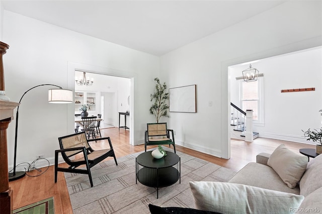 3330 W 30th Ave, Denver, CO 80211 - living room with a chandelier, stairs, light wood finished floors, and baseboards