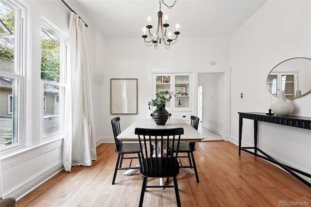3330 W 30th Ave, Denver, CO 80211 - dining room with a chandelier, light wood finished floors, and baseboards