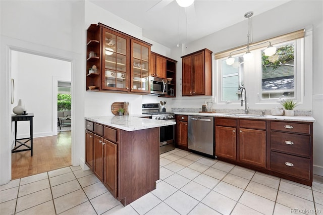 3330 W 30th Ave, Denver, CO 80211 - kitchen featuring stainless steel appliances, a sink, a peninsula, light stone counters, and glass insert cabinets