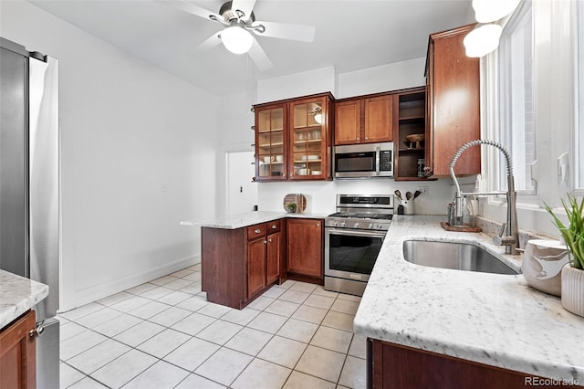 3330 W 30th Ave, Denver, CO 80211 - kitchen featuring stainless steel appliances, a sink, light tile patterned flooring, a peninsula, and ceiling fan