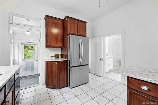 3330 W 30th Ave, Denver, CO 80211 - kitchen with freestanding refrigerator, light tile patterned floors, and light stone countertops