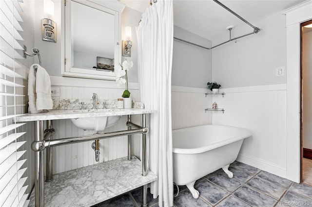 3330 W 30th Ave, Denver, CO 80211 - bathroom with a freestanding tub, wainscoting, and a sink