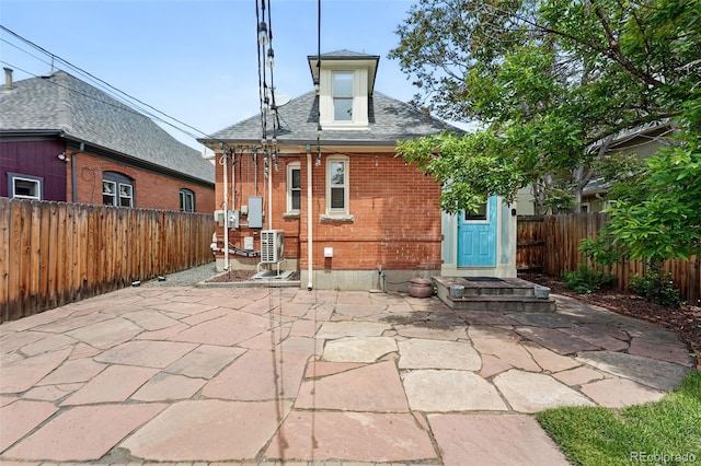 3330 W 30th Ave, Denver, CO 80211 - back of property with brick siding, a fenced backyard, a patio, and roof with shingles
