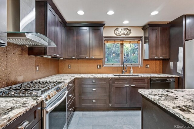 kitchen with black dishwasher, wall chimney range hood, sink, gas range, and light tile patterned flooring