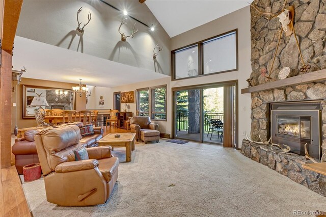 living room with an inviting chandelier, high vaulted ceiling, a fireplace, and wood-type flooring