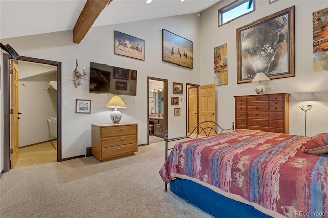 carpeted bedroom featuring beam ceiling, a towering ceiling, and ensuite bathroom