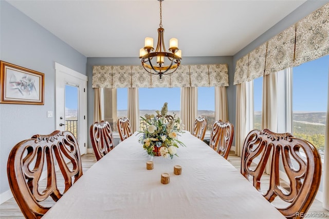 dining room featuring light hardwood / wood-style floors and an inviting chandelier