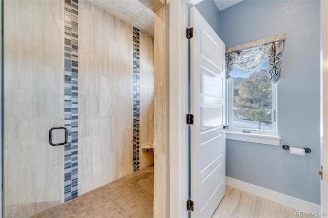 bathroom featuring a shower with door