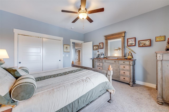 bedroom featuring ceiling fan, light colored carpet, and a closet