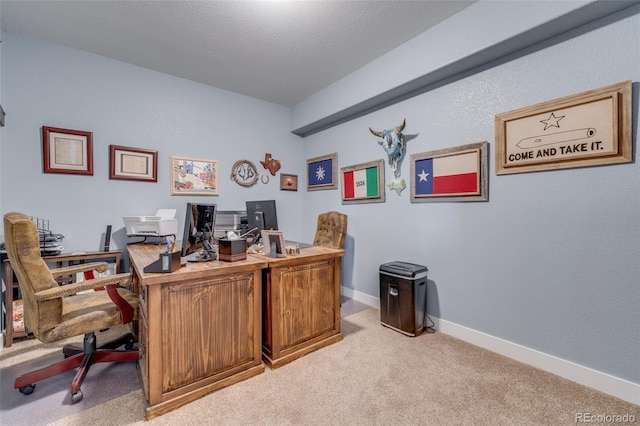 carpeted office featuring a textured ceiling