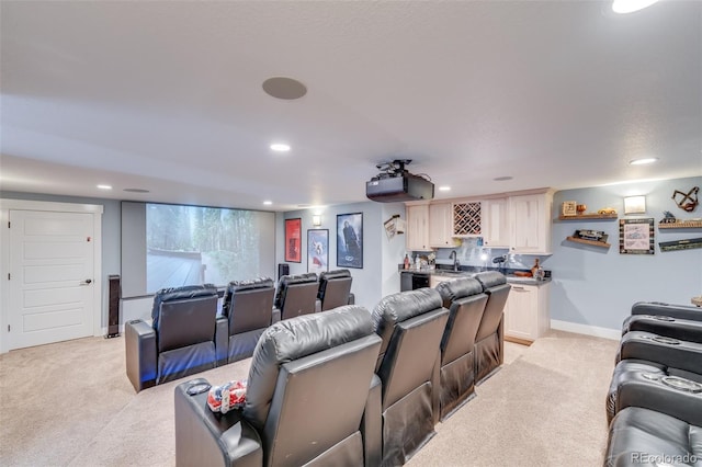 cinema room with wet bar and light colored carpet