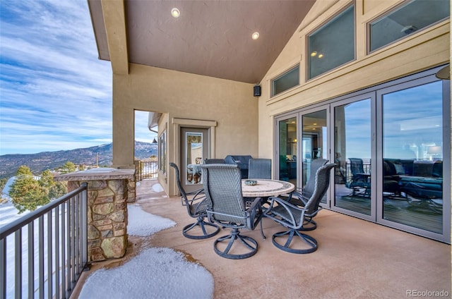 view of patio with a mountain view and a balcony