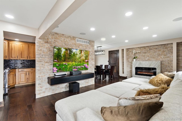 living room featuring dark hardwood / wood-style floors and a fireplace