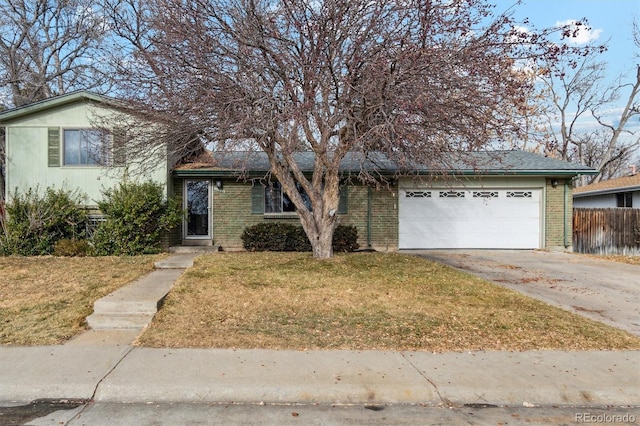 view of front of property featuring a front yard and a garage