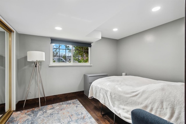 bedroom with dark hardwood / wood-style flooring