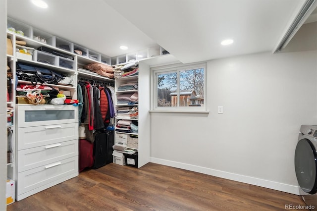 spacious closet with washer / dryer and dark wood-type flooring