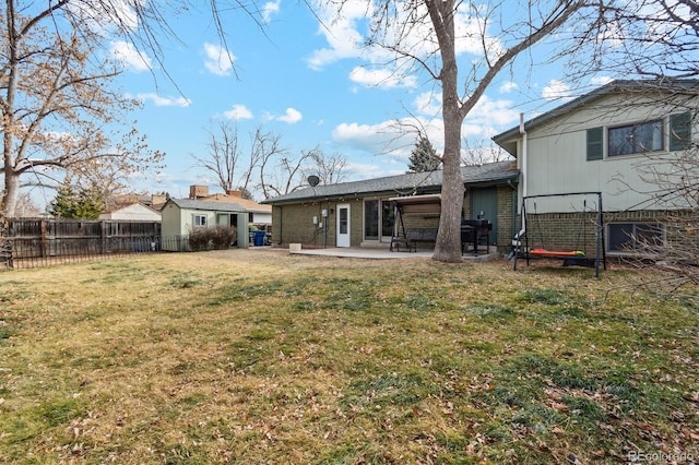 back of property featuring a patio, an outdoor structure, and a lawn