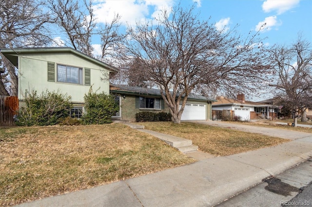 tri-level home with a front yard and a garage