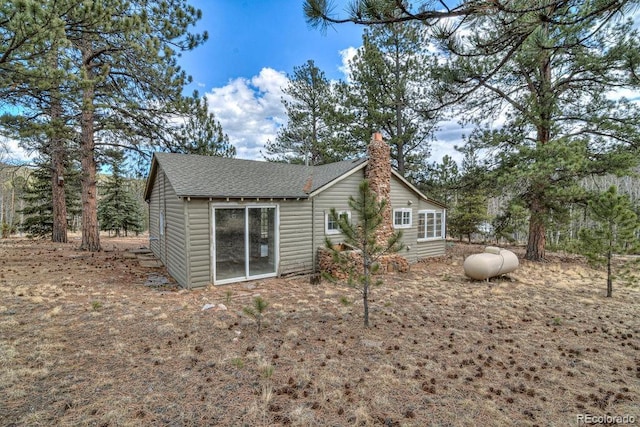 11 Hupp Rd, Bailey, CO 80421 - back of property featuring roof with shingles and a chimney
