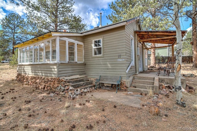 11 Hupp Rd, Bailey, CO 80421 - view of property exterior with a sunroom and a patio area