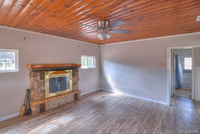 11 Hupp Rd, Bailey, CO 80421 - unfurnished living room with ornamental molding, wood finished floors, a ceiling fan, a stone fireplace, and wooden ceiling