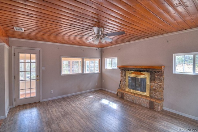 11 Hupp Rd, Bailey, CO 80421 - unfurnished living room with visible vents, a stone fireplace, a wealth of natural light, and wood finished floors