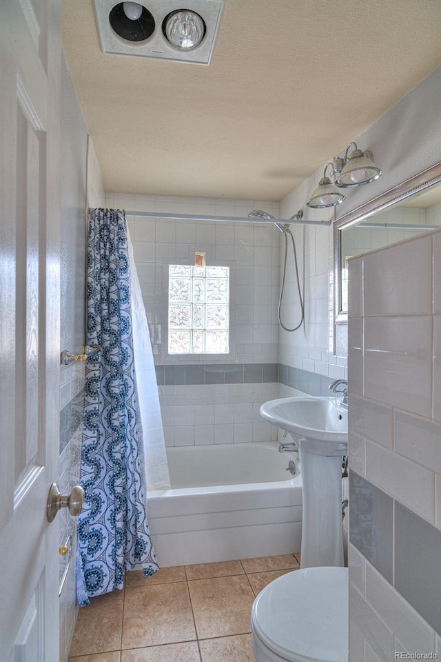 11 Hupp Rd, Bailey, CO 80421 - bathroom featuring tile patterned flooring, shower / bathtub combination with curtain, tile walls, toilet, and a textured ceiling