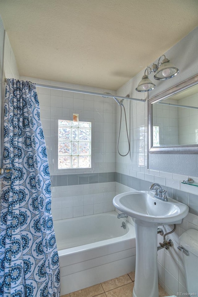 11 Hupp Rd, Bailey, CO 80421 - full bathroom with tile walls, a textured ceiling, tasteful backsplash, shower / tub combo, and tile patterned flooring